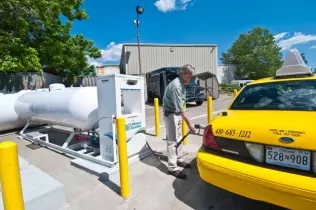 An autogas-powered taxi refueling at a station