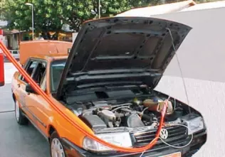 A Volkswagen Santana taxi refueling with CNG at a station in Brazil